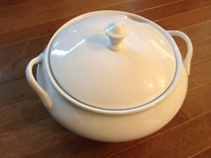 Stylish white porcelain soup tureen with ladle and lid